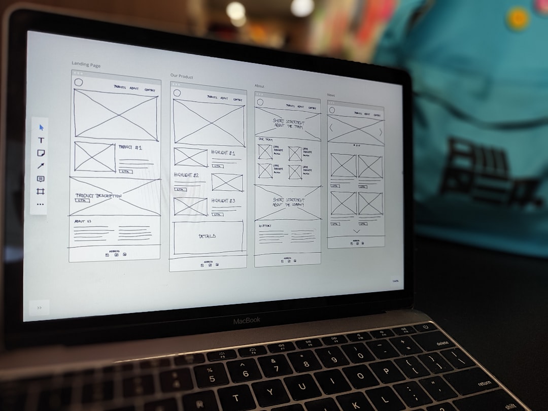 services-01 A website wireframe on a macbook screen on an office desk.